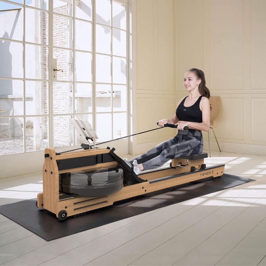 Lady rowing on the Water Rowing Machine.